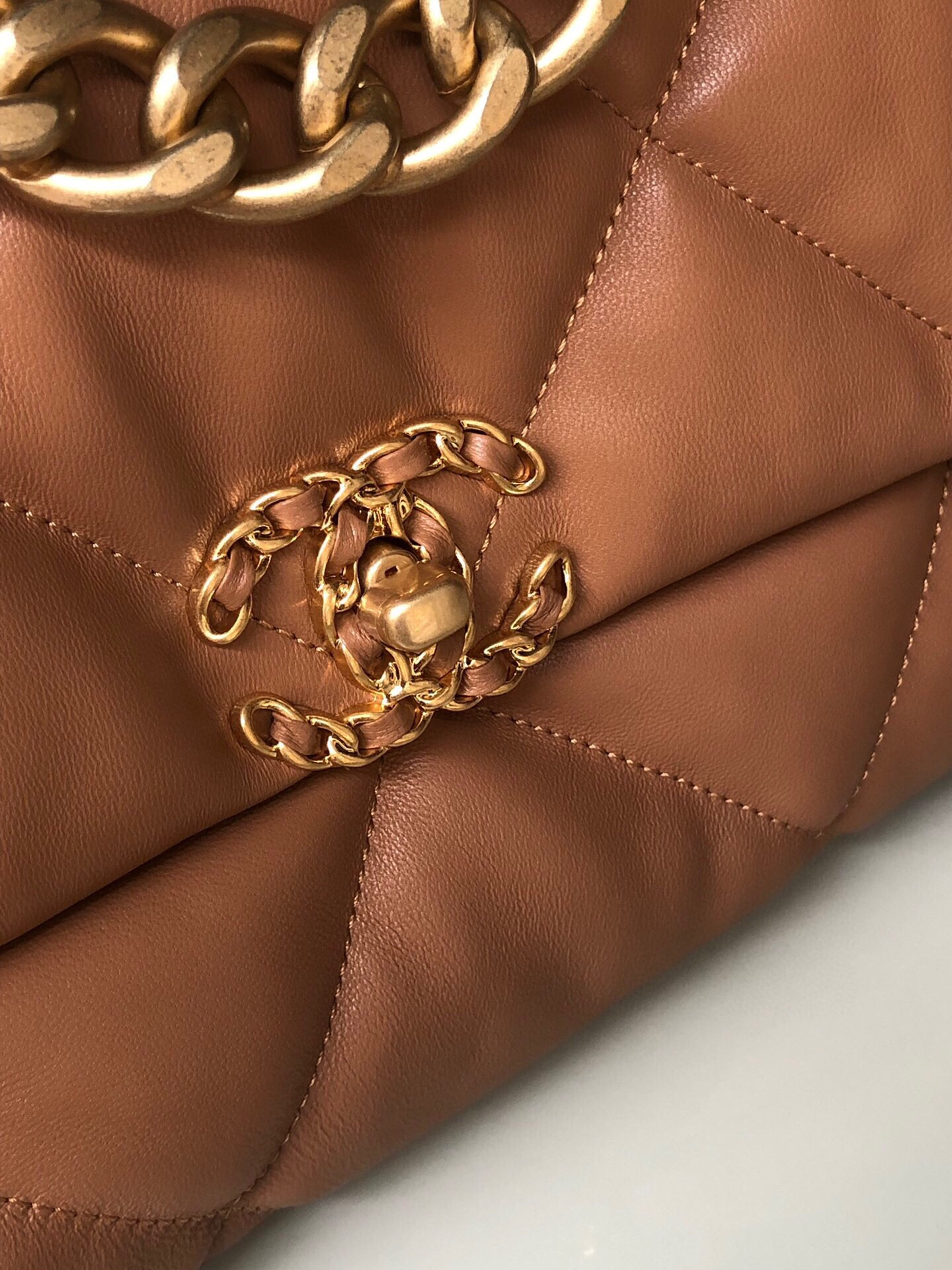 Ch*el 19 large handbag shiny leather, gold-tone, silver-tone & ruthenium-finish metal caramel 7.8 × 11.7 × 3.9 in