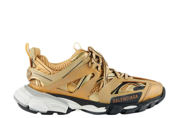 UA WMNS TRACK TRAINER GOLD